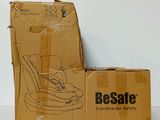 cardboard box with a baby seat on top of it sitting on a table