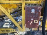 a machine that is sitting on the ground next to a pile of dirt