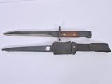 two knives are laying on a white surface next to each other