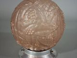 an image of a pink glass ball on a metal stand