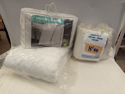 deux oreillers et un oreiller posés sur un lit dans une chambre