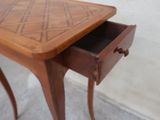a small wooden table with a drawer underneath it