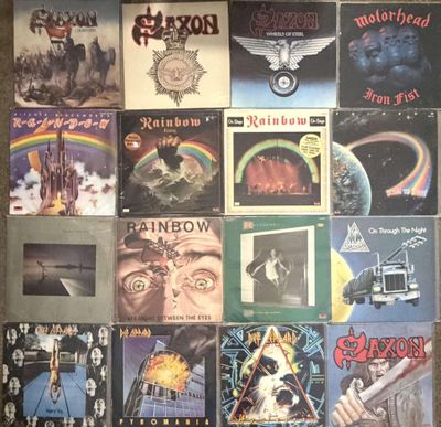 many different album covers on the wall of a room