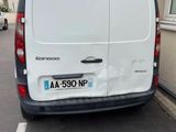the back of a white van parked on the side of a road