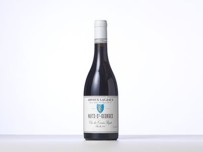 the bottle of wine is sitting on the table with a white background