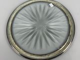 an image of a silver plate with a circular design on it