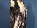 black and white tie dyed shirt on a mannequin stand