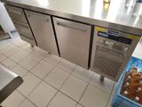 stainless steel counter top in a commercial kitchen with bottles of beer