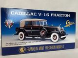 an old model of a black car with a tan top