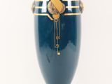 a large blue vase with a gold decoration on it