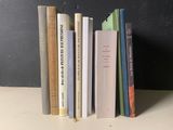 a lot of books that are stacked on a shelf
