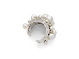a close up of a ring with pearls on a white background