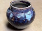 a blue and purple vase sitting on a table