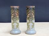 two vases that are sitting on a table