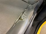 the interior of a car with a hole in the front seat