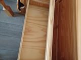 a person that is opening a drawer in a room