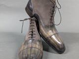 a pair of men ' s shoes on a grey surface