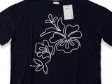 a black t - shirt with white flowers on it