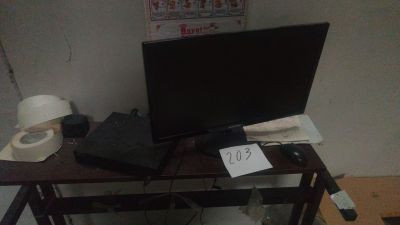 a computer desk with a monitor and a laptop on it