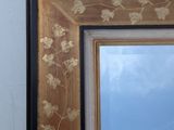 a picture of a mirror hanging on the wall