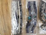 three pairs of hair clips in plastic bags on a table
