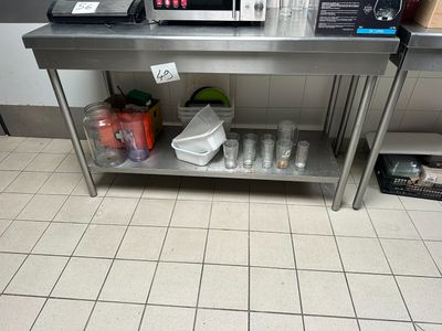 a stainless steel table with a microwave on top of it
