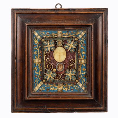 an old wooden frame with a picture of a man and a woman on it