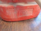 a red gas can sitting on a wooden table