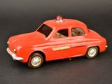a red toy car with a red light on top of it