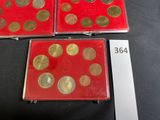 three red cases with gold coins on them sitting on a table