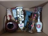 a cardboard box filled with assorted items and a vase