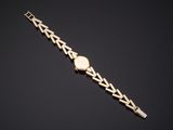 a gold bracelet with a heart shaped clasp
