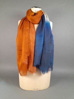 an orange, blue and brown scarf on a mannequin mannequin