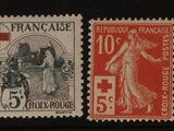quatre timbres différents, portant une croix rouge sur fond noir
