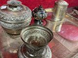 a silver tray with silver objects on it on a table