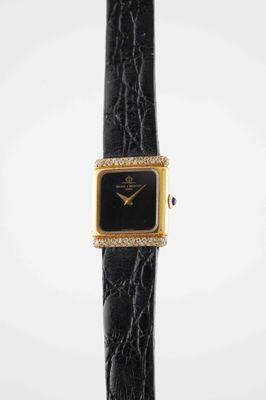 a close up of a watch on a black leather strap