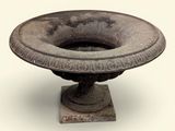 a stone bowl on a pedestal on a white background