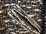 black and white patterned jacket with zippers on the front