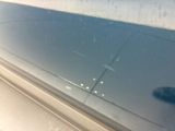 a close up of a glass window with a small object in it