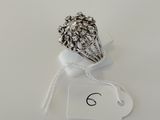 silver plated ring with a flower design on a white background
