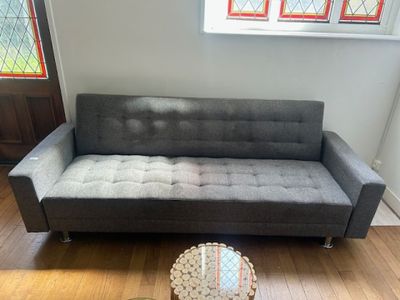 a couch and a table in a room with a stained glass window