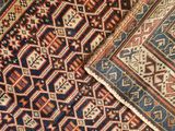 a close up of a rug with different colors and patterns