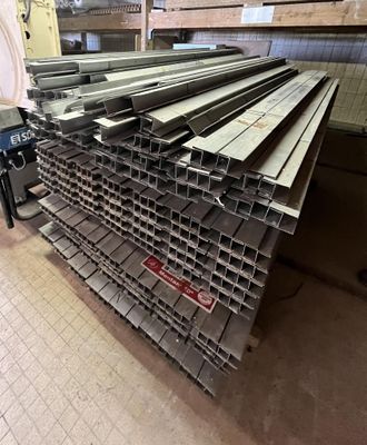 a pile of steel bars stacked on top of each other