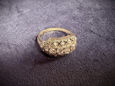 a close up of a gold ring on a black surface