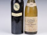 two bottles of wine sitting next to each other on a table