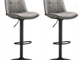 a pair of grey leather bar stools on a white background