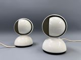 pair of white and black table lamps on a gray surface