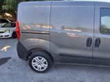 the grey van is parked in a parking lot with other cars
