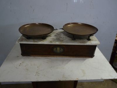 two metal bowls on a marble table with a wooden box