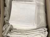 a box with a lot of white napkins in it
